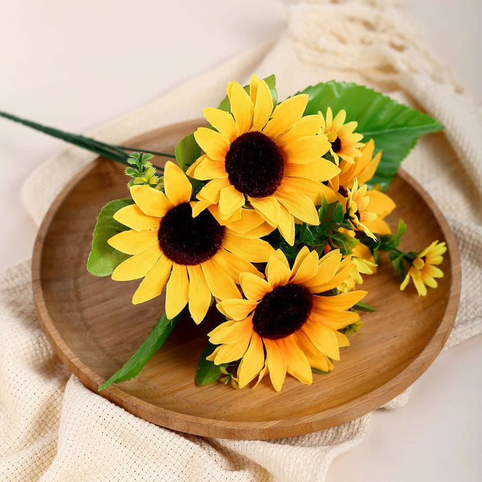Bouquet of vibrant artificial sunflowers on a wooden tray.