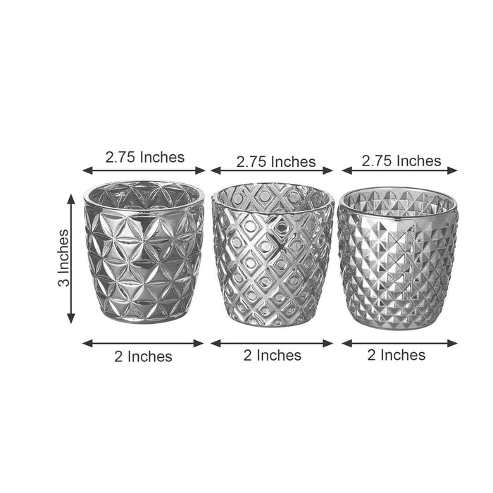 Set of three decorative silver planters, each 3 inches tall and 2 inches wide.