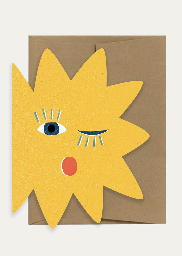 A diecut sun shaped card with blinking face.