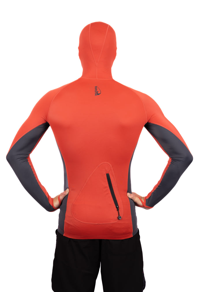 Back view of a male model wearing the Waihana Canyon Hooded Voyager Rashguard in orange-red and charcoal grey, featuring a full hood, rear zip pocket, and contrast sleeve panels on a white studio background.