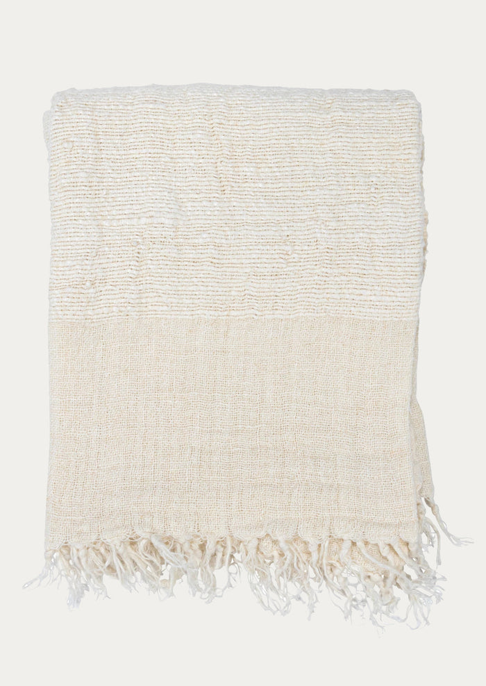 An ivory linen throw with a mix of different weave gauges.