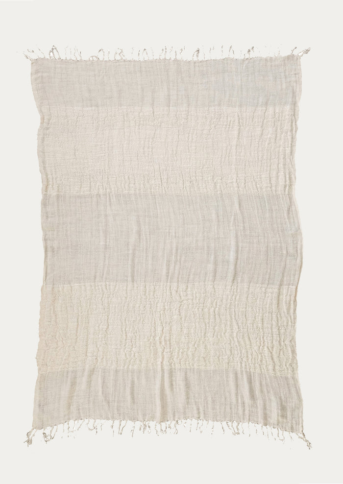 An ivory linen throw with a mix of different weave gauges.