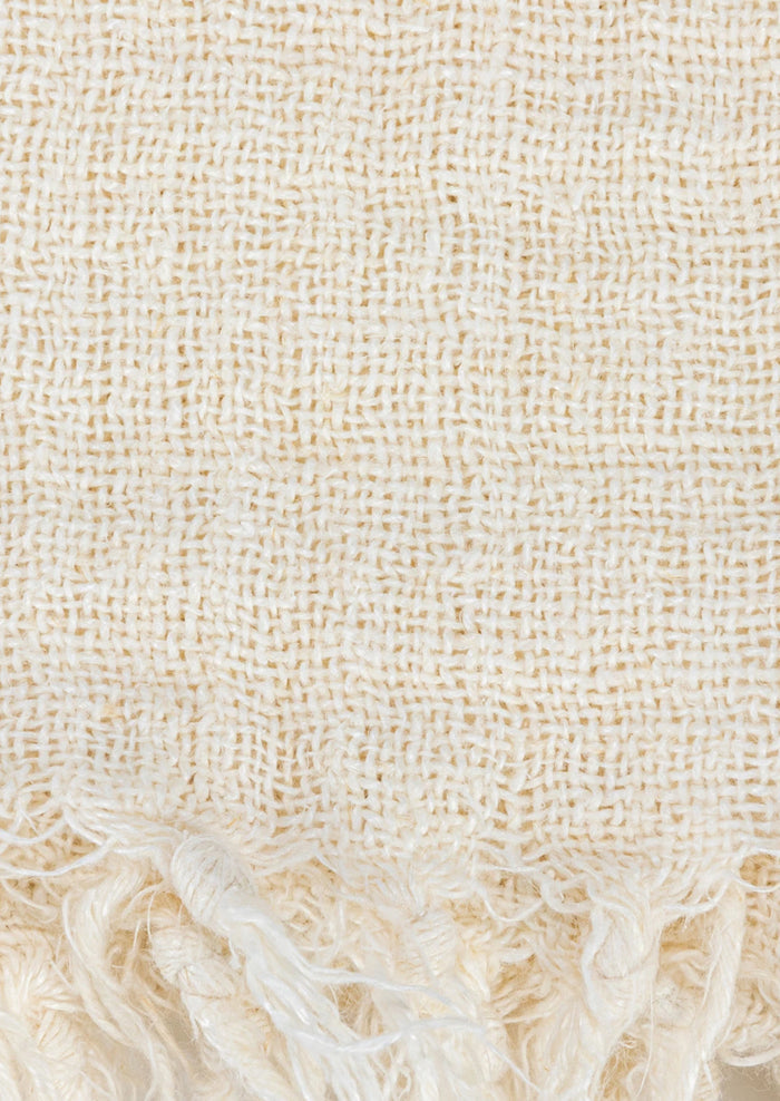 An ivory linen throw with a mix of different weave gauges.