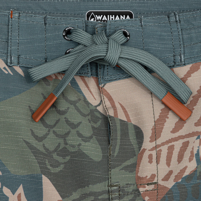Close-up of the teal drawstring waistband on Waihana's Hawaiian Brushstroke Cruiser board shorts, featuring branded eyelets and a tropical brushstroke print in teal, sand, and rust tones.