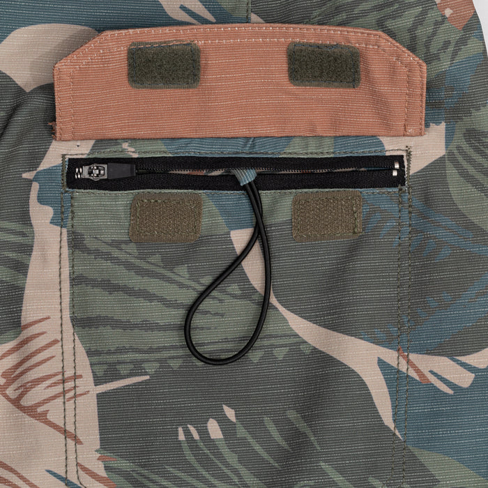 Close-up of the zippered cargo pocket with velcro flap and elastic cord pull on Waihana's Hawaiian Brushstroke Cruiser board shorts.