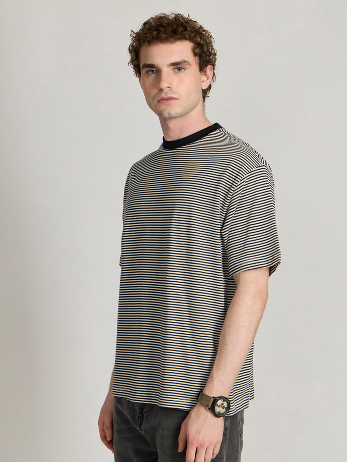 Man wearing a white and black striped crew t-shirt