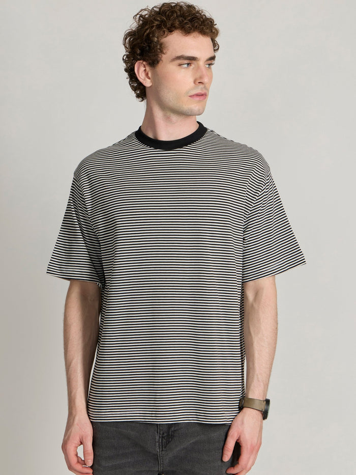 Man wearing a white and black striped crew t-shirt