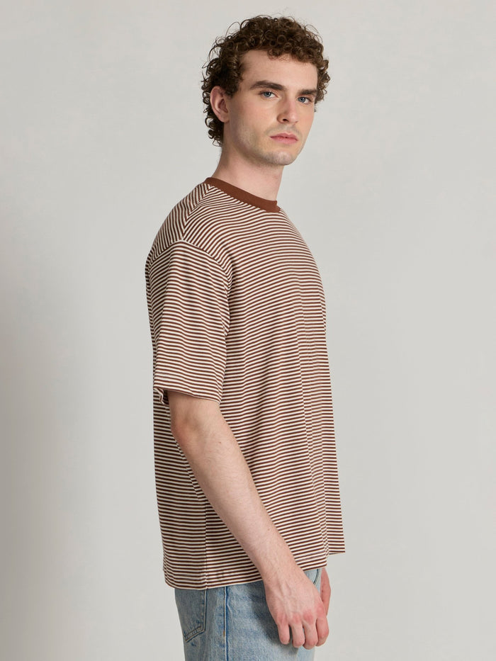 Man wearing a brown striped crew t-shirt