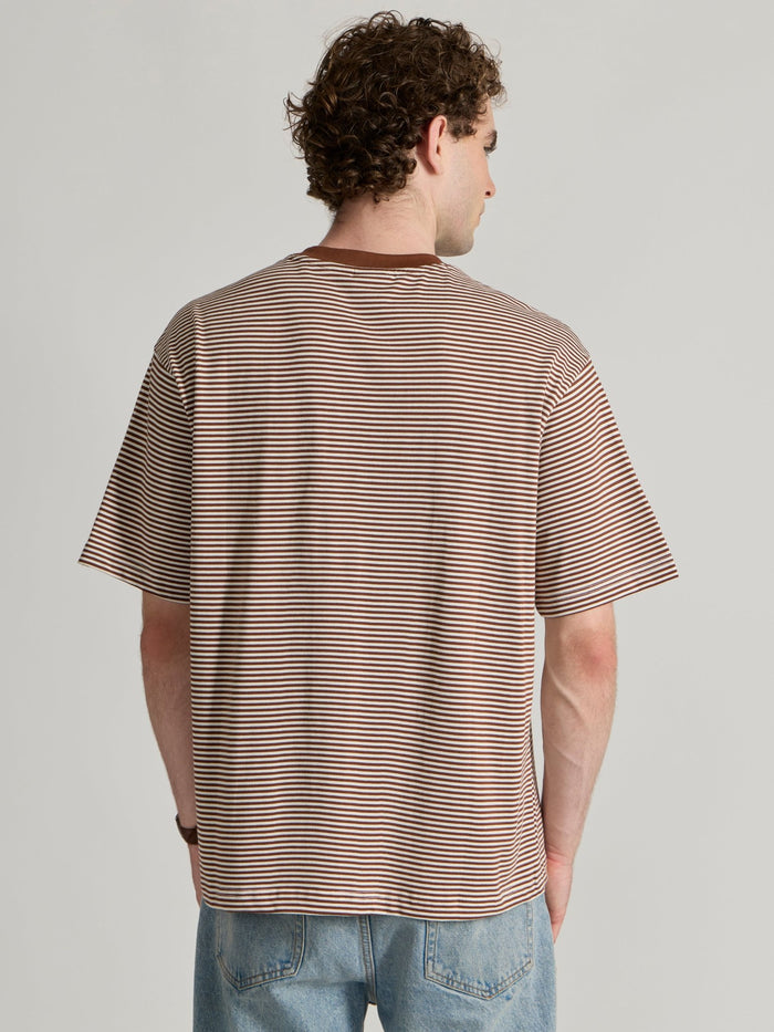 Man wearing a brown striped crew t-shirt