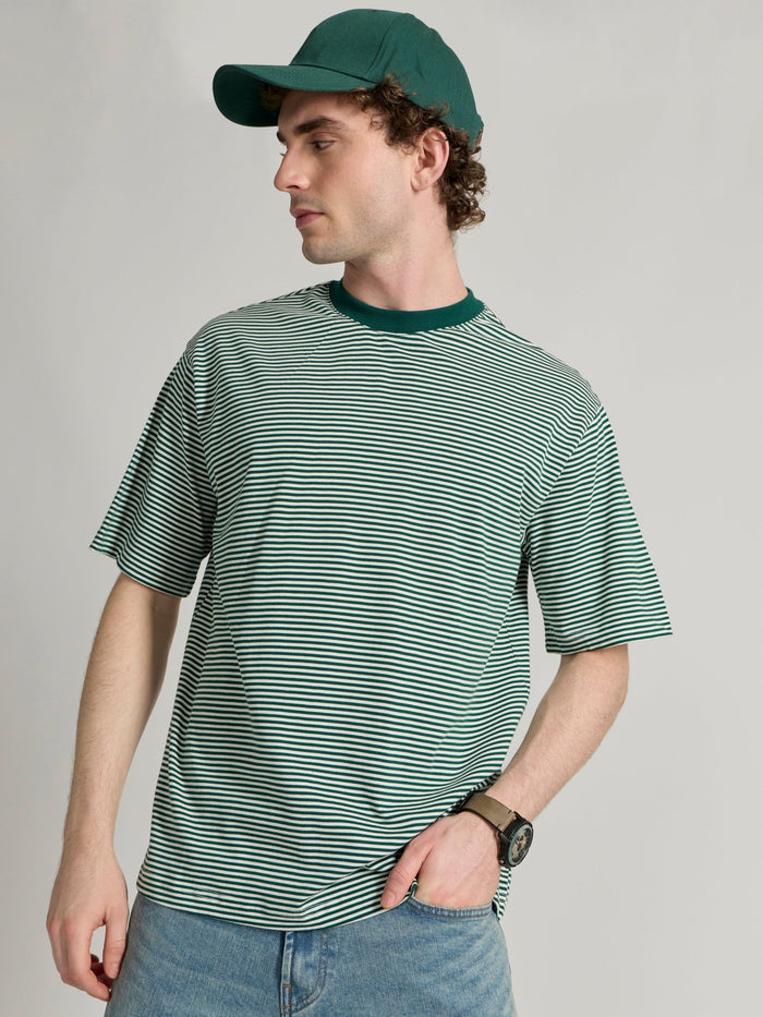 Man wearing a green  and white striped crew t-shirt