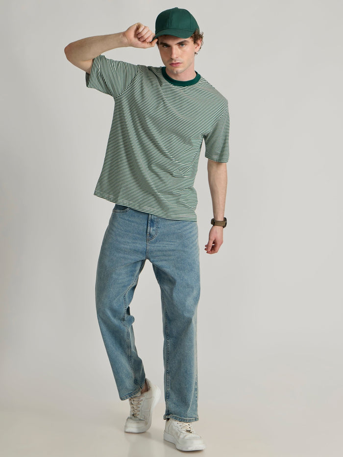Man wearing a green  and white striped crew t-shirt