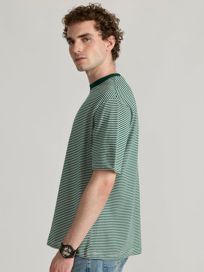 Man wearing a green  and white striped crew t-shirt