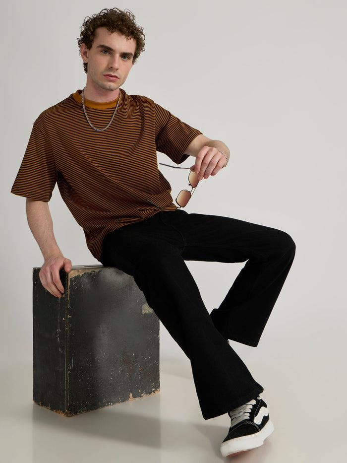 Man wearing a mustard yellow and black striped crew t-shirt