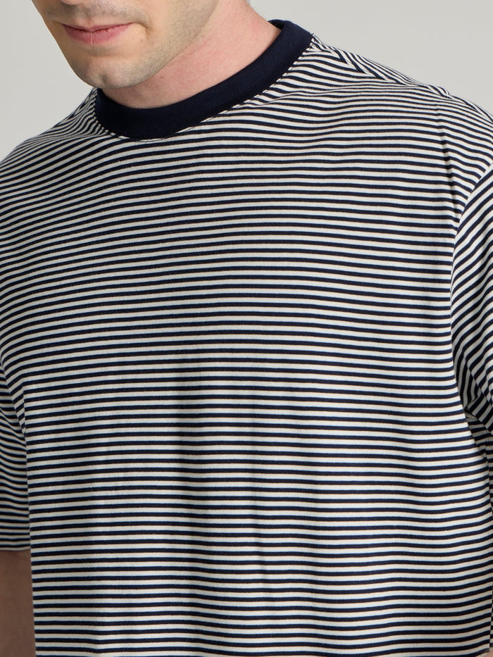 Man wearing a navy blue striped crew t-shirt