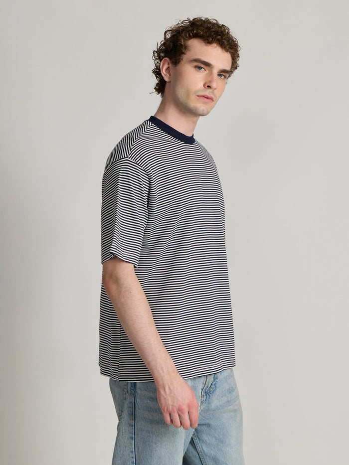 Man wearing a navy blue striped crew t-shirt