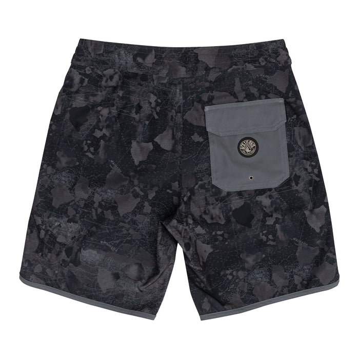 Rear view of Waihana Island Aloha W1 board shorts in a dark navy camo print with subtle map graphics, featuring a grey utility back pocket with Waihana logo badge and grey hem trim.