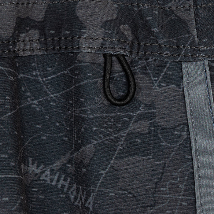Close-up of the elastic drawstring loop and waistband stitching on Waihana's Island Aloha W1 board shorts, featuring a dark navy tropical print and contrast grey side stripe.