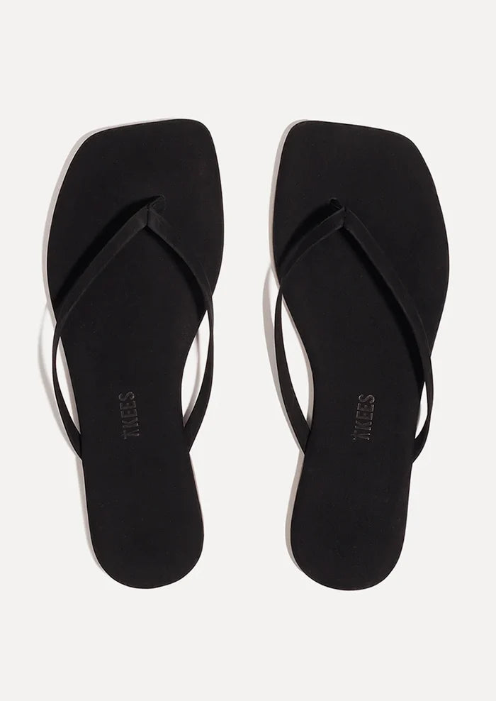 A pair of suede square toe TKEES sandals in black.