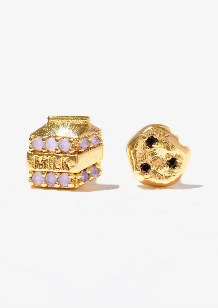 A pair of gold stud earrings in mismatched milk and cookies.