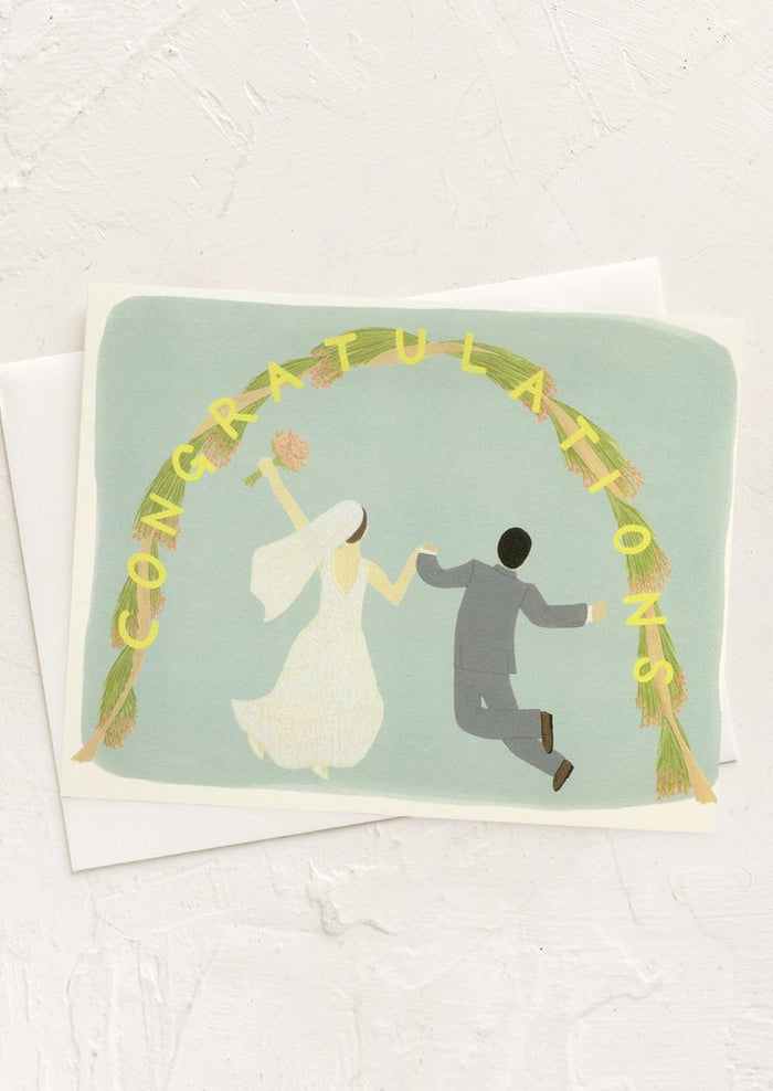 An illustrated card with bride and groom leaping under an arch.