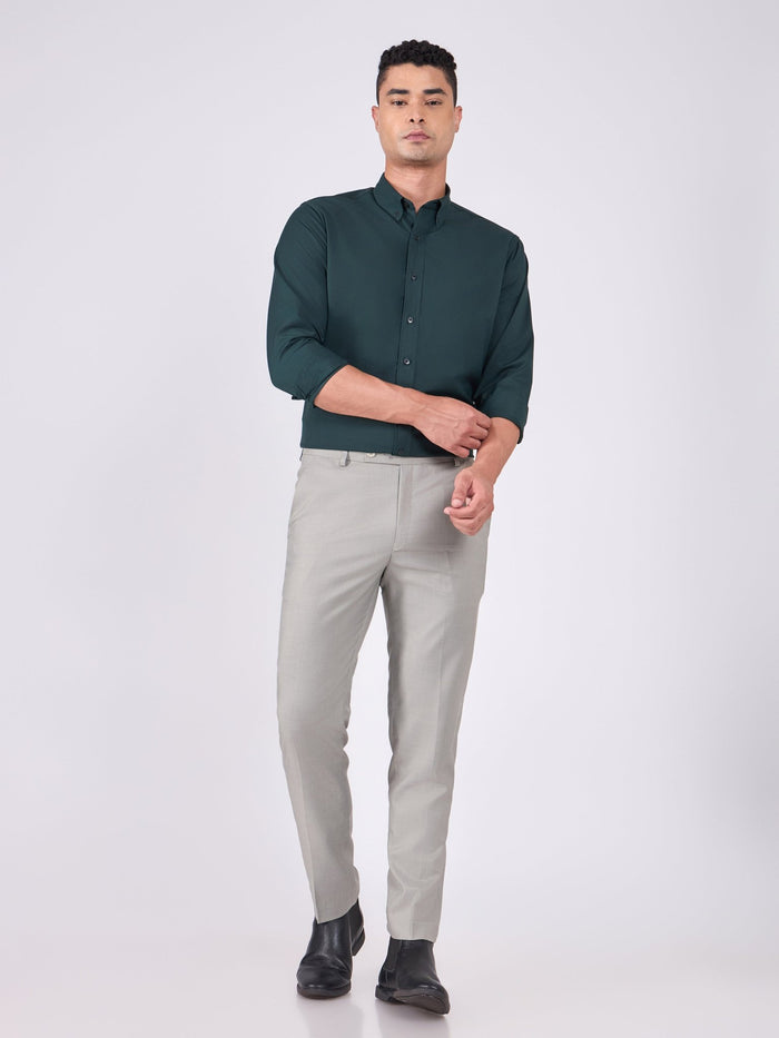 Man wearing Tencel  prussian blue shirt and light gray pants on a white background