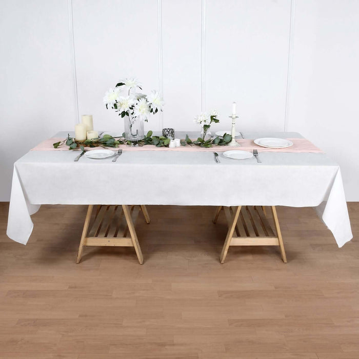 Elegant dining table setup with flowers and candles for a stylish event.