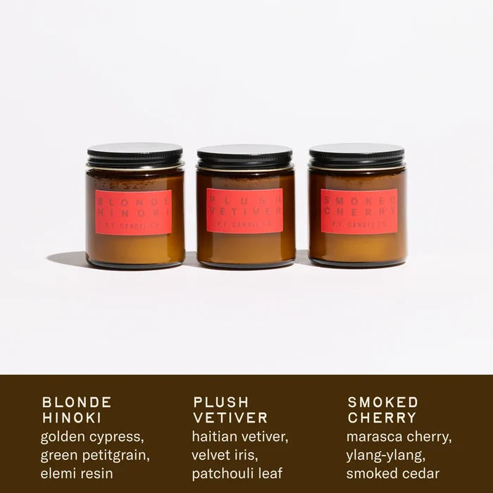 Three small candles with labels on a white background