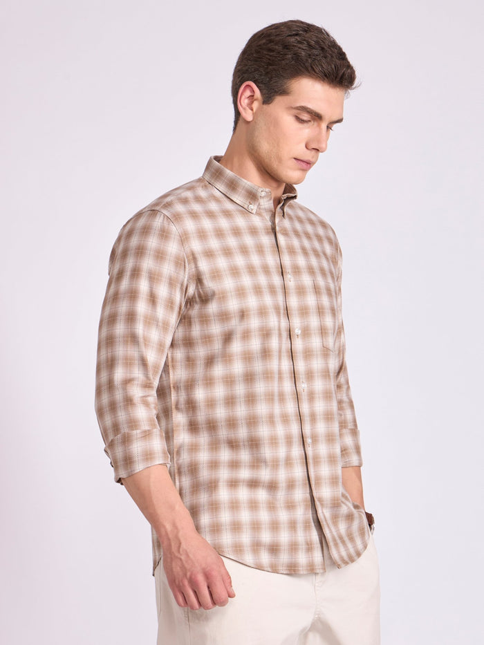 Man wearing a brown  checkered shirt.