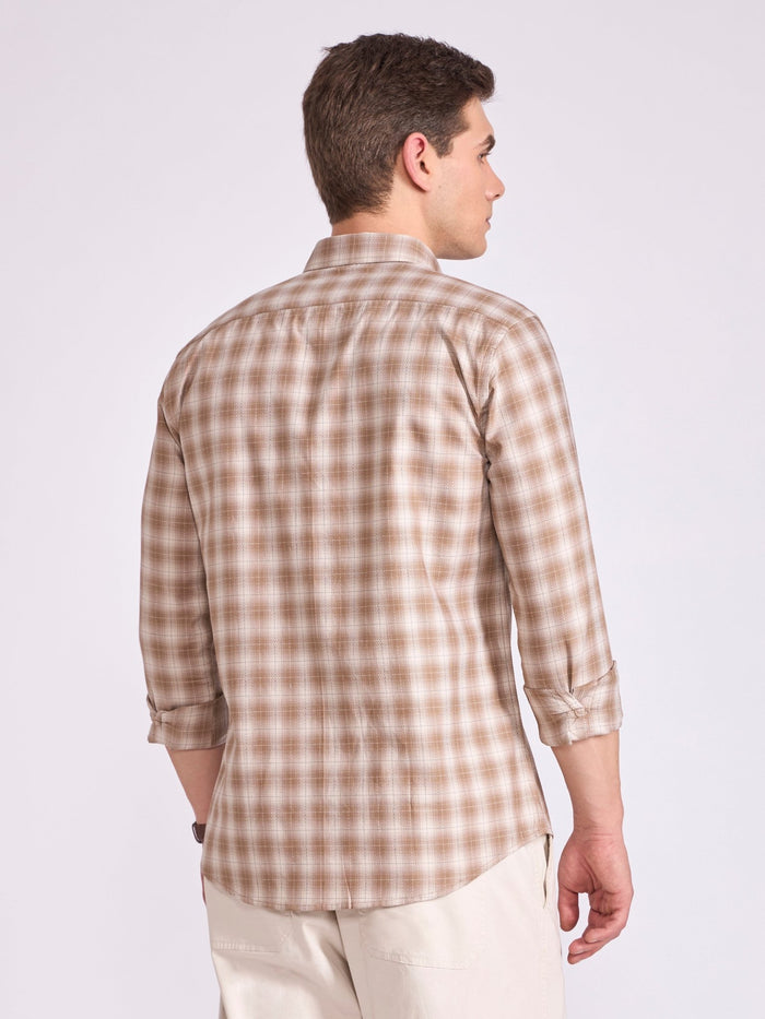 Man wearing a brown  checkered shirt.