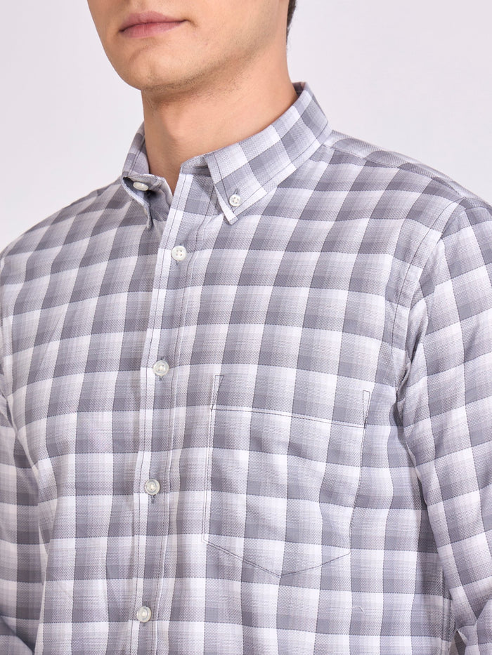 Man wearing a classic gray checkered shirt.