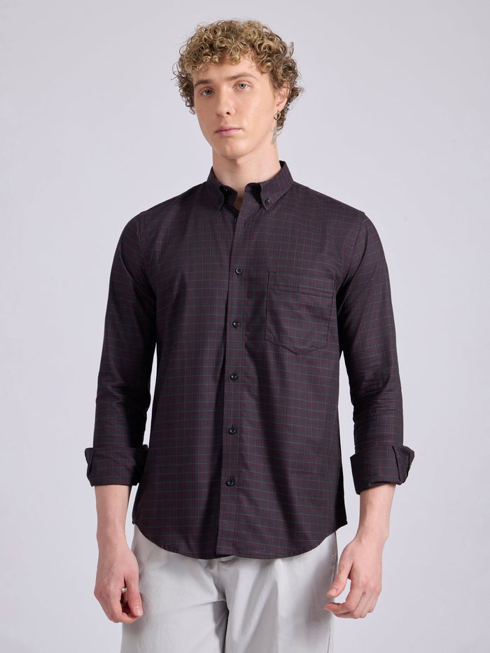 Man wearing a dark burgundy checkered shirt.