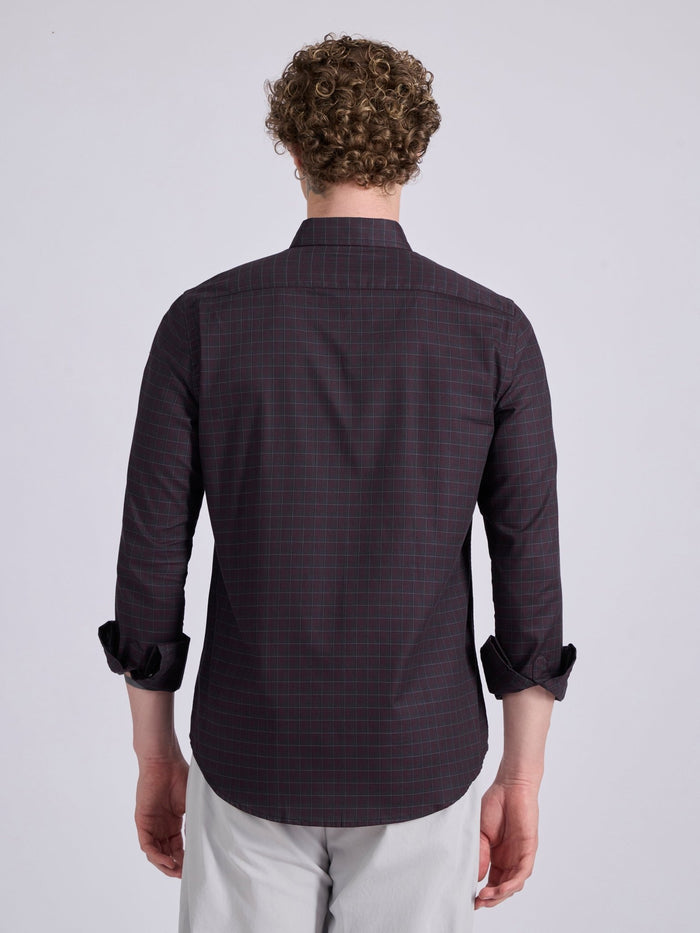 Man wearing a dark burgundy checkered shirt.
