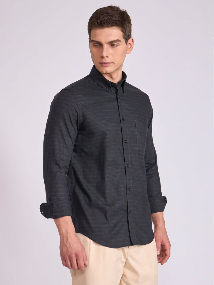 Man wearing a dark slate  gray checkered shirt.