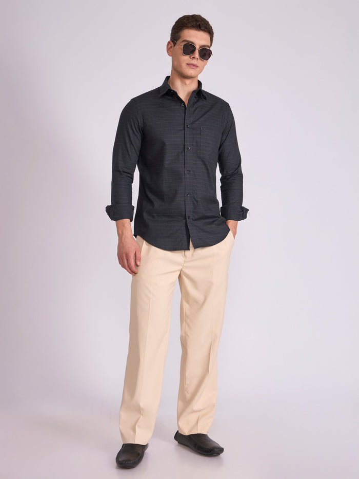 Man wearing a dark slate  gray checkered shirt.