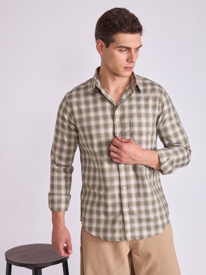 Man wearing a Olive green checkered shirt.