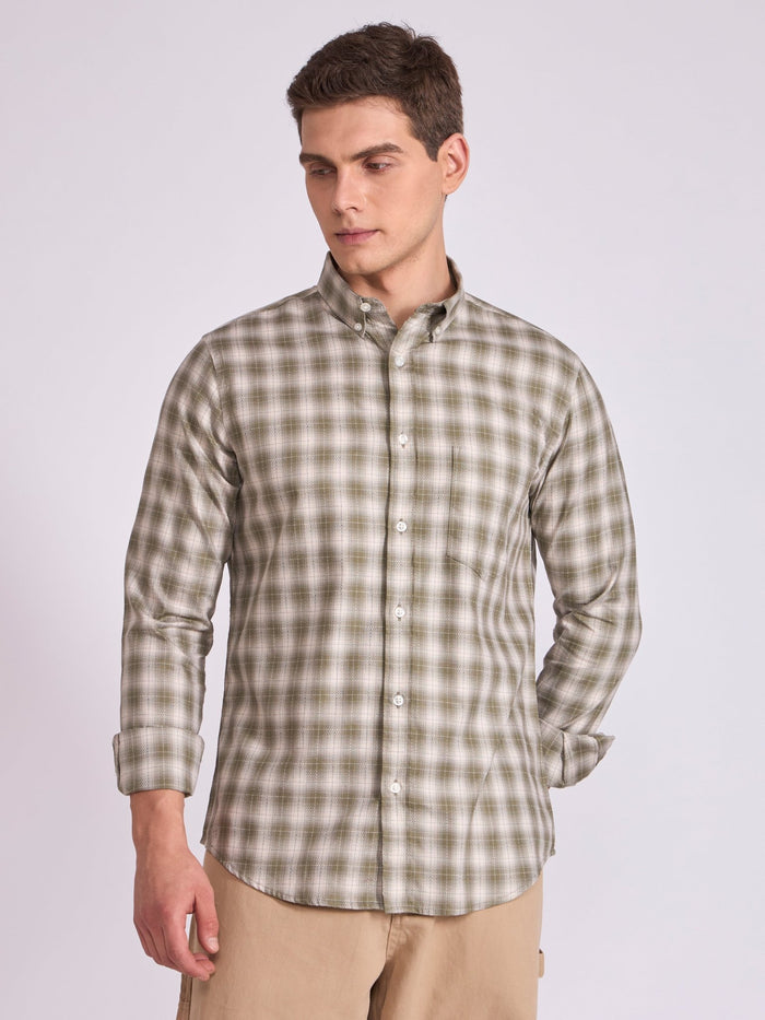 Man wearing a Olive green checkered shirt.