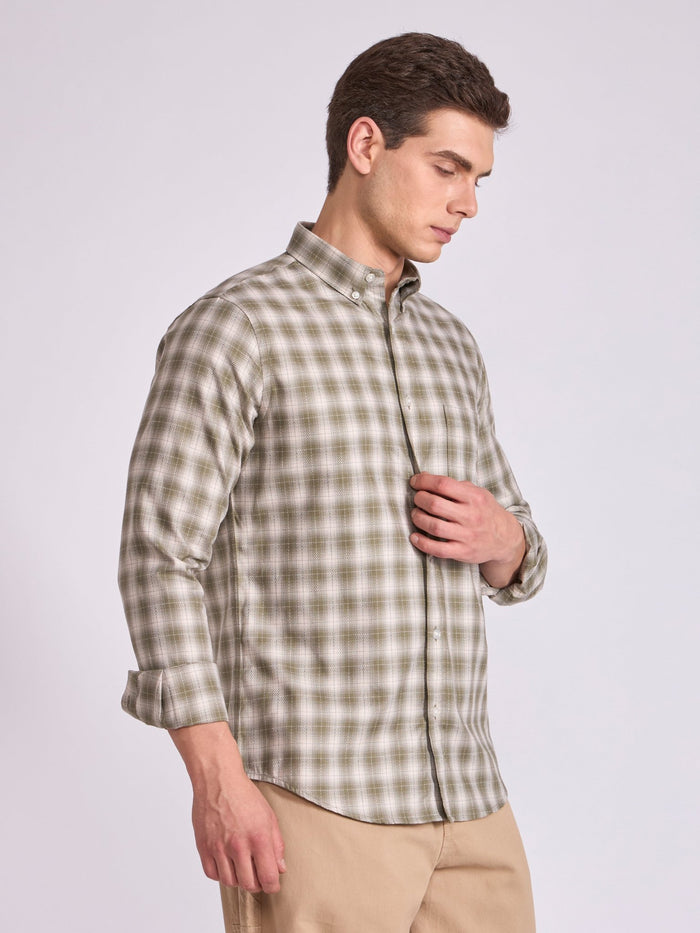 Man wearing a Olive green checkered shirt.