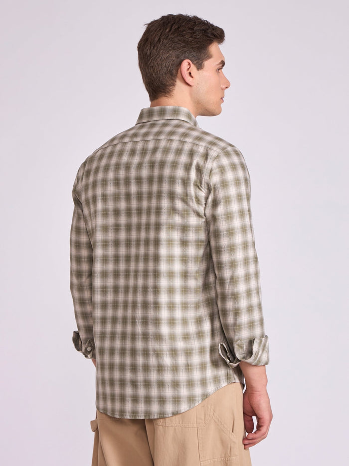Man wearing a Olive green checkered shirt.