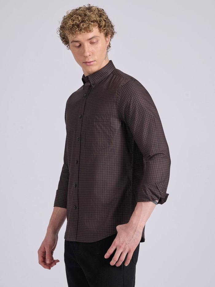 Man wearing a dark brown micro checkered shirt .