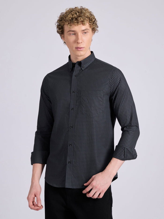 Man wearing a dark steel blue micro checkered shirt .