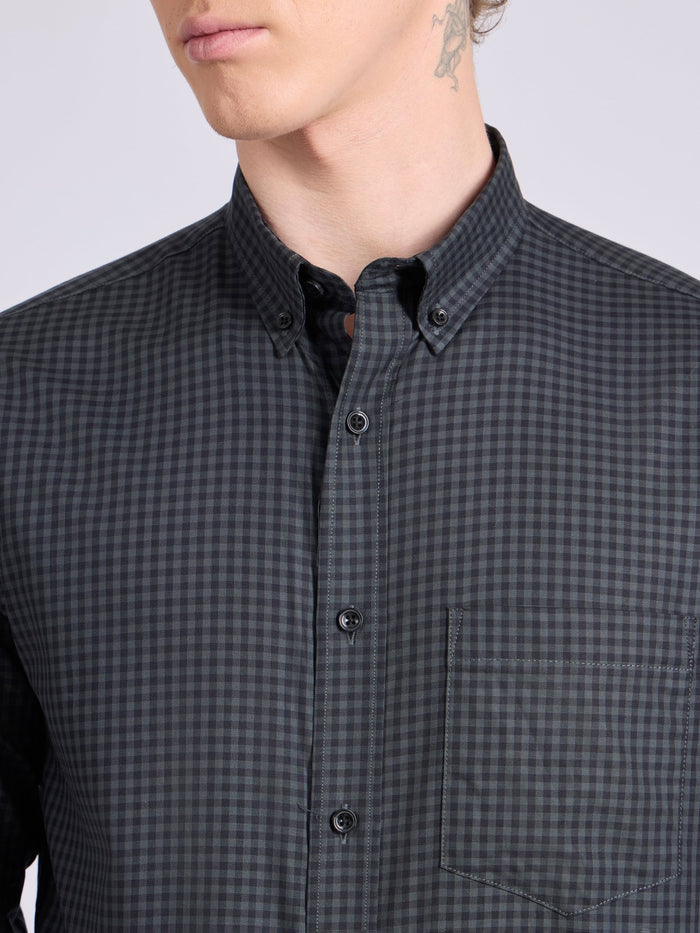 Man wearing a dark steel blue micro checkered shirt .