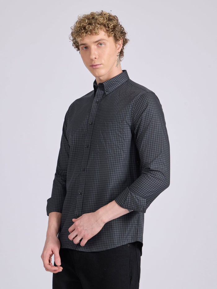 Man wearing a dark steel blue micro checkered shirt .