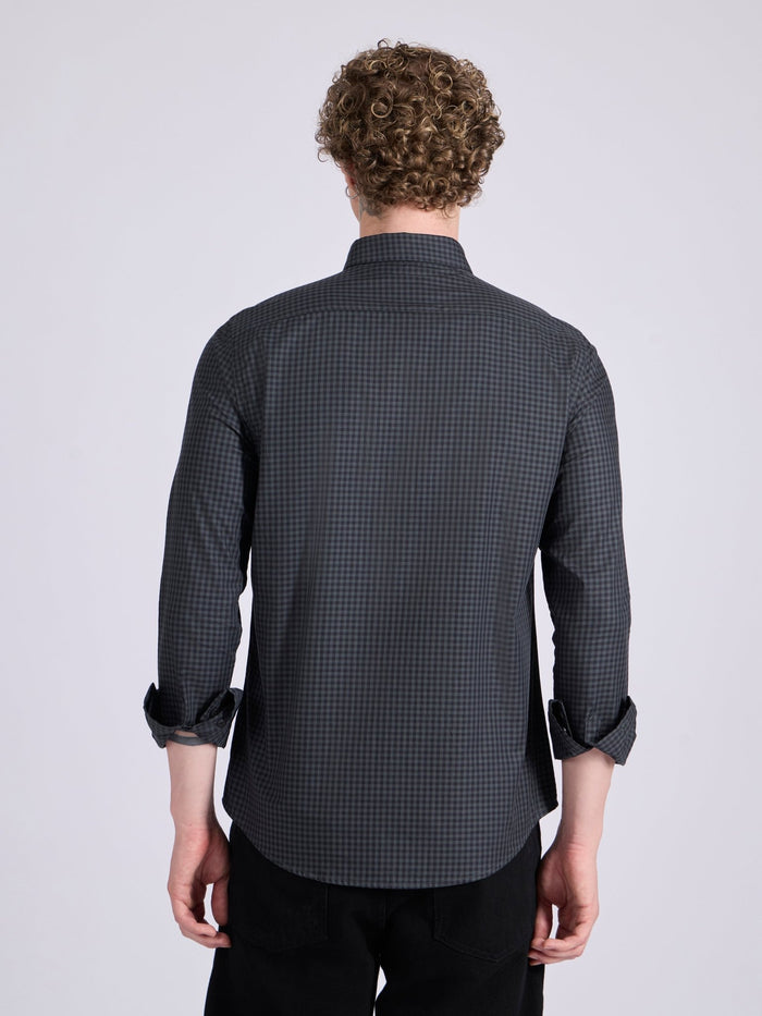 Man wearing a dark steel blue micro checkered shirt .