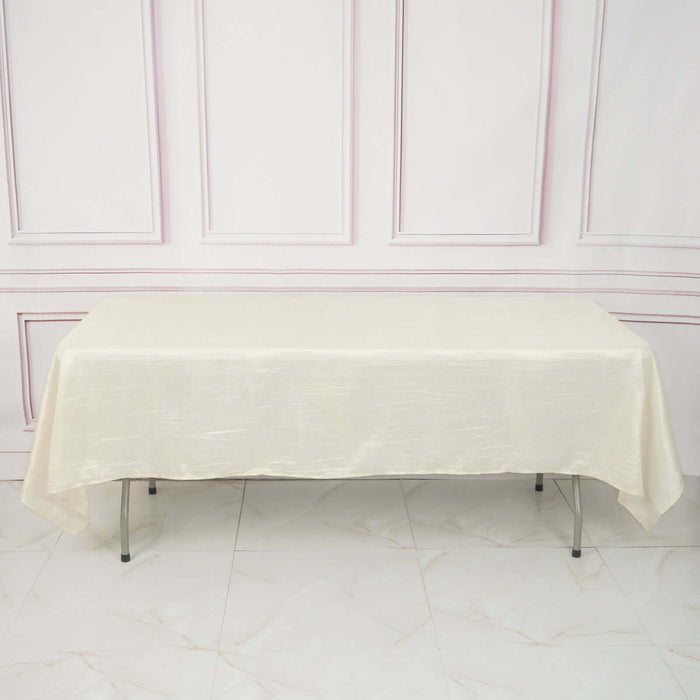 Cream tablecloth draped over a table in a studio setting.
