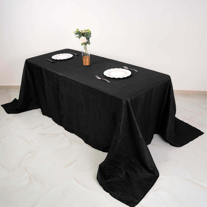 Black tablecloth draped elegantly over a table set for dining.