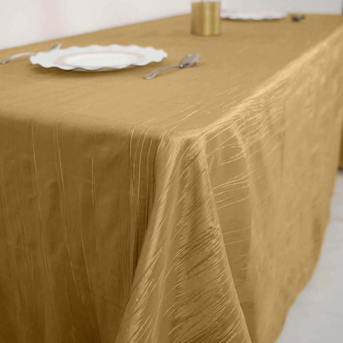 Gold textured tablecloth draped elegantly on a dining table.