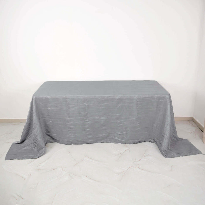Gray textured tablecloth draped over a table on a white background.