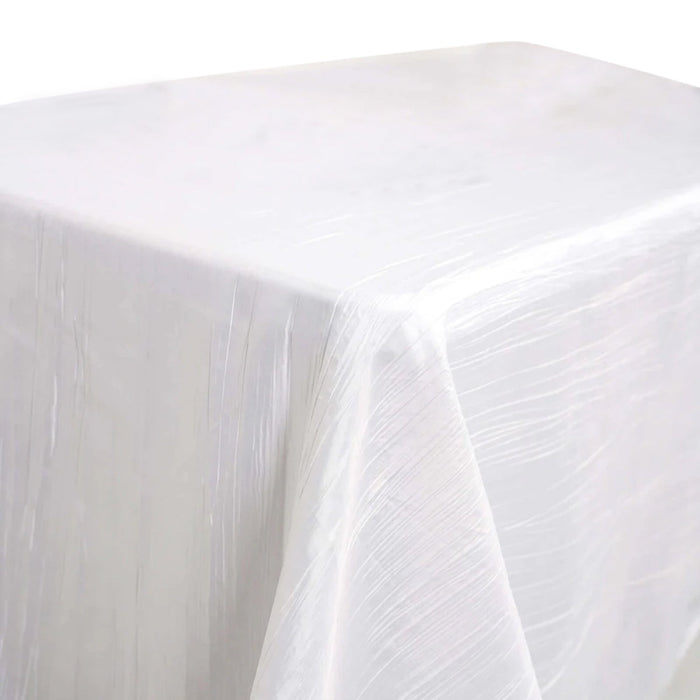 White tablecloth with a textured finish draped over a table.