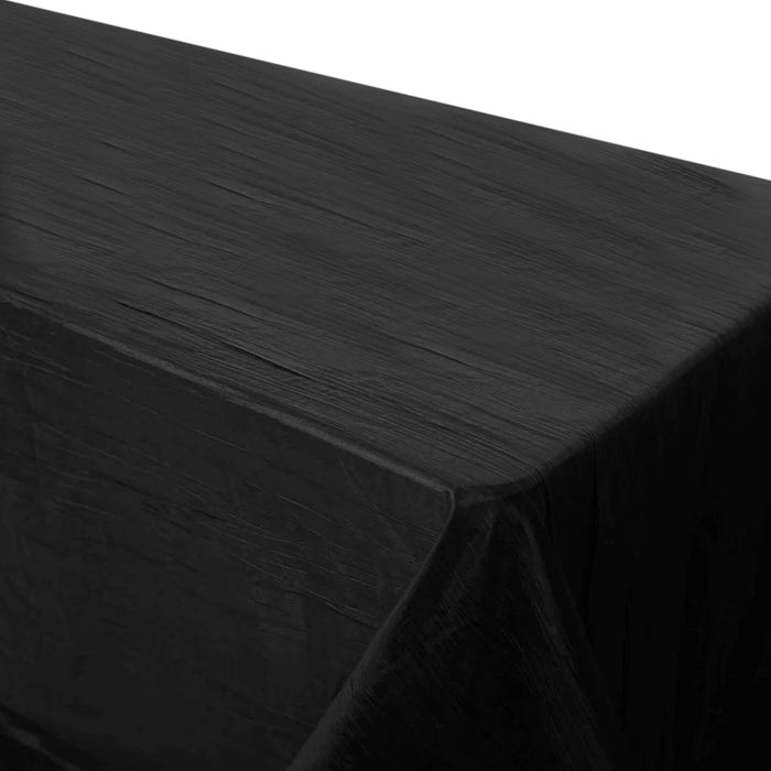Black tablecloth with a textured finish, draping elegantly over a table.