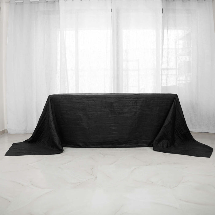 Black tablecloth draped over a table in a bright, airy room.